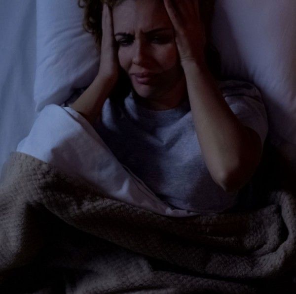 Person resting with a migraine headache